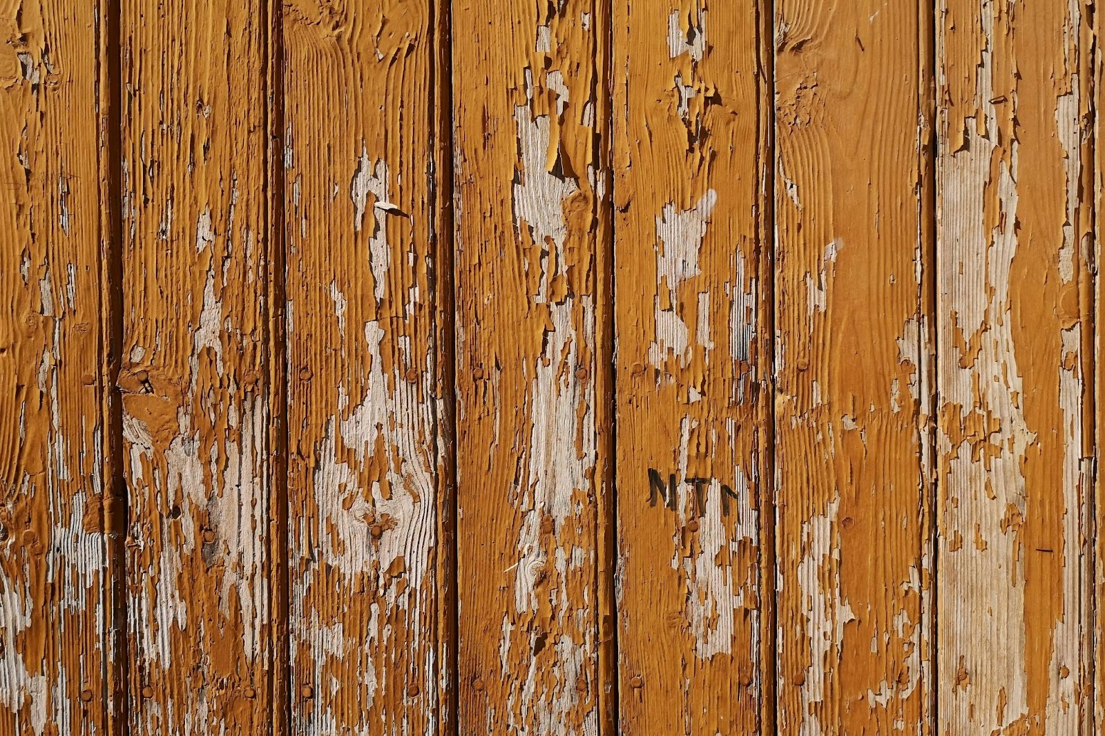 A chipped and worn wooden fence